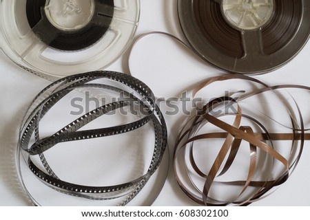 Old reels with a black and white film and magnetic tape