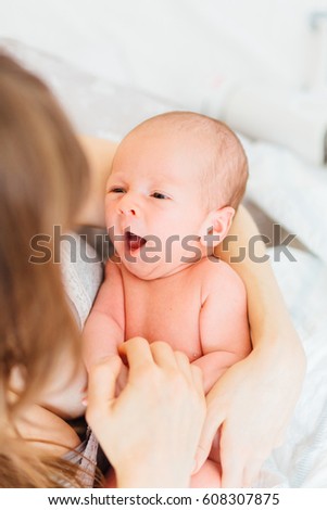 Top view of happy mother hugging newborn son. Beautiful conceptual image of Maternity.