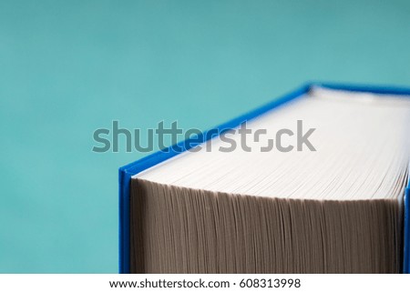 Book on a blue background. Back to school. Copy space. Top view.