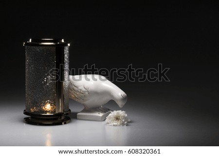 cemetery candle holder for sympathy card on dark background