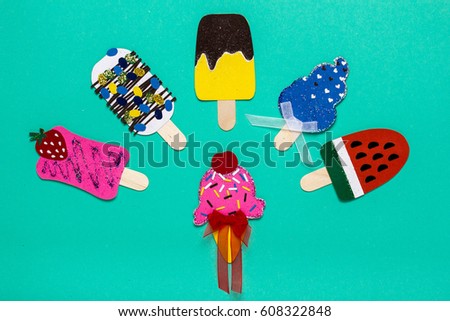 Paper ice cream on a blue background. Applique. Funny, children's pictures.