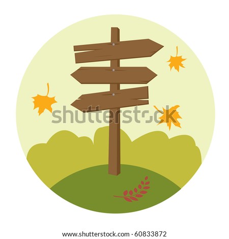 Wooden direction sign with fallen leaves