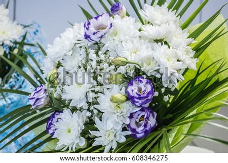 Fresh big white chrysanthemum purple roses closeup magic blurred background