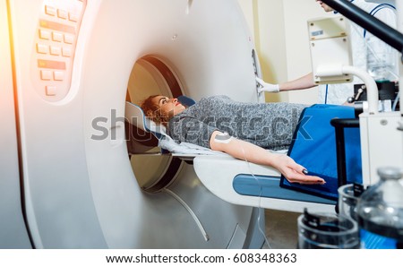 Medical equipment. Doctor and patient in the room of computed tomography at hospital. Royalty-Free Stock Photo #608348363