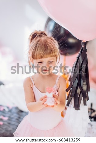 Beautiful little girl celebrating birthday party. Family celebration of the child