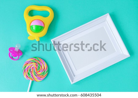 birth of child - blank picture frame on turquoise background