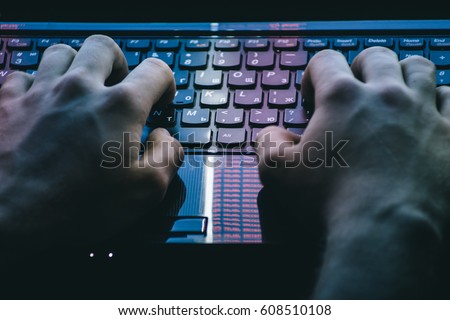 Russian hacker hacking the server in the dark Royalty-Free Stock Photo #608510108
