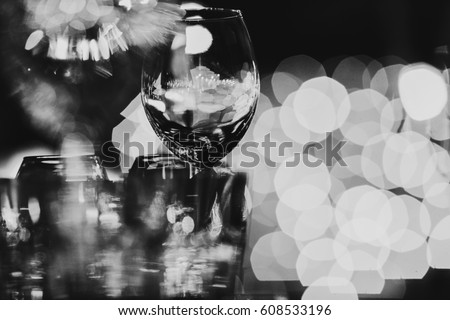 Blurred picture of glassware standing on the table Royalty-Free Stock Photo #608533196