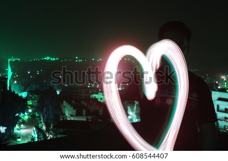 Heart symbol drawn through light painting/long exposure photography 