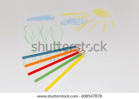 Child's color drawing on a white paper with color pencils