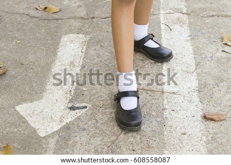 background textured shoes girl on cement floors arrow
