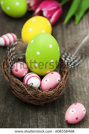 Nest with easter eggs  on a old wooden table