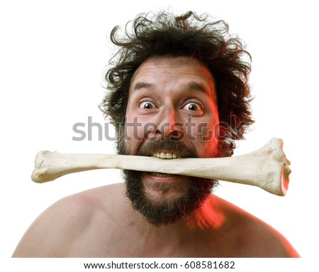 Caveman, manly man with Big Bone, showing of his strength and masculinity: Plus: he needs Meat. Royalty-Free Stock Photo #608581682