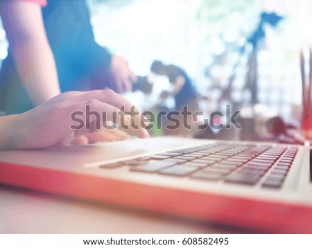 Woman hand working on laptop keyboard buttons with blurred focus studio room, business and education concept