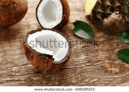 Half of fresh coconut on wooden background