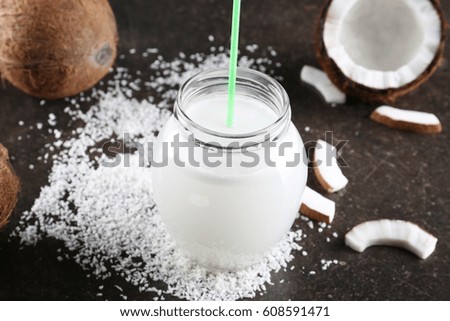 Composition with fresh coconut milk on dark table