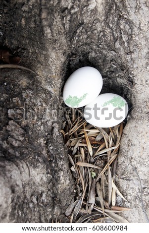 Decorated Easter eggs lie in a hollow tree
