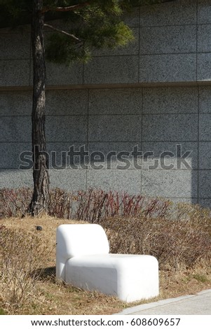 white marble chair and pine tree