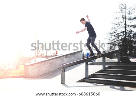 Skater sliding down the rail - boardslide trick
