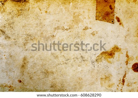 Fragment of old paper texture with dark spots. Abstract background