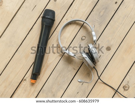 Microphone with head phone on wooden background