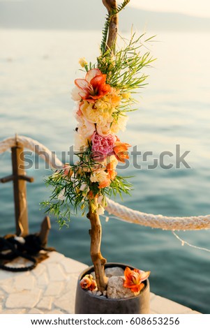 Wooden arch for the wedding ceremony at sunset. On the shore of the Bay of Kotor, Tivat, Montenegro