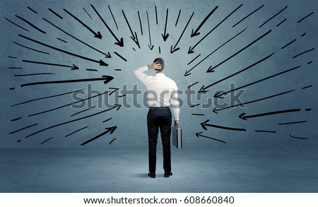 A confused businessman under pressur after making a bad decision illustrated with drawn arrows pointing at him in clear blue urban space concept