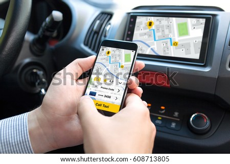 man hands in car holding phone with application call taxi on screen and multimedia system