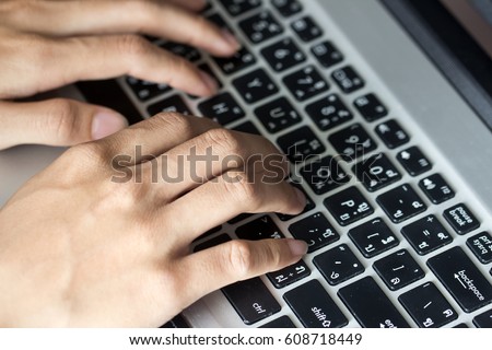 Close up picture of a  hands typing on a  keyboard, chatting online