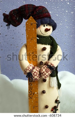 Snowman standing in the snow against a blue starry  background.