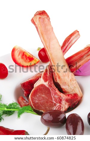 served raw fresh veal ribs with vegetables