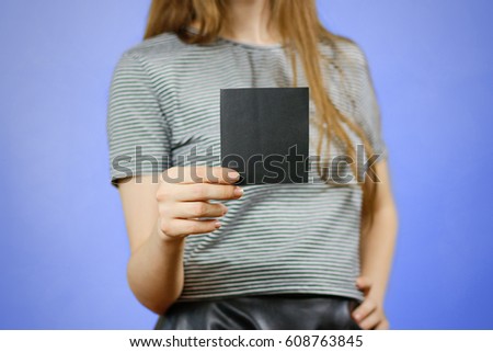 Woman showing square blank black flyer paper. Leaflet presentation. Pamphlet hold hands. Girl show clear offset paper. Sheet template. Booklet design sheet display read first person