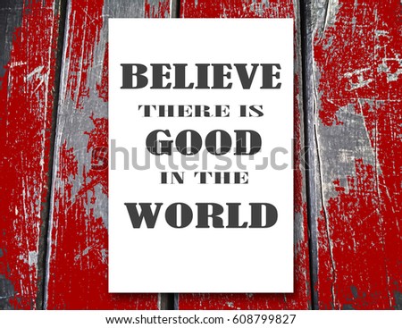 Believe there is good in the world. Motivation, poster, quote, background wood, white paper, black letters, blurred image
