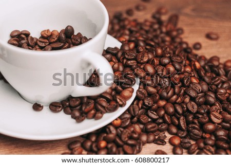 Coffee in beans with a white mug