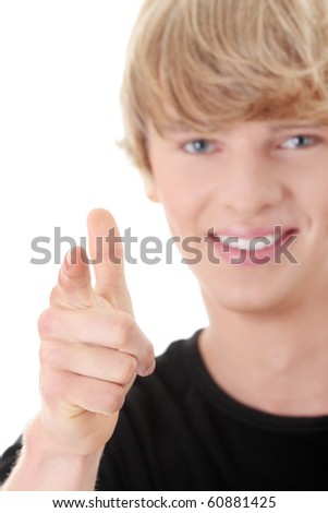 Portrait of a young man smiling, pointing at you. Isolated on white. Focus on hand