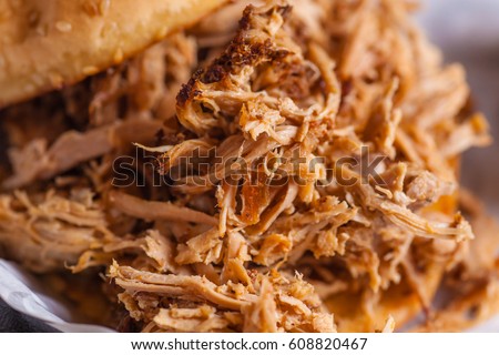 Close up shot of pulled pork fibers in a sandwich freshy served on a platter Royalty-Free Stock Photo #608820467