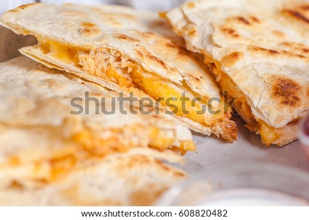 Close up shot of several freshly served cheese quesadillas on a platter Royalty-Free Stock Photo #608820482