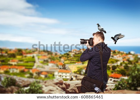 Photographer takes pucture standing on mountain