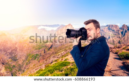 Photographer taking picture of rocky mountains