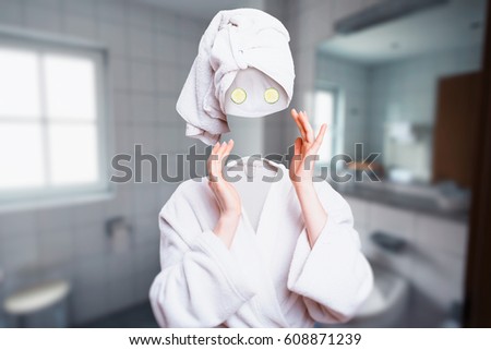 Girl touch her invisible face, cucumbers on eyes Royalty-Free Stock Photo #608871239