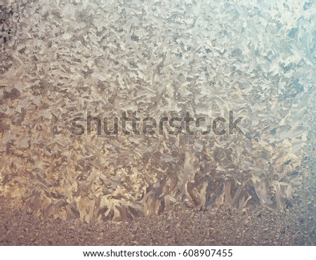 Frozen window glass with icy ornaments.