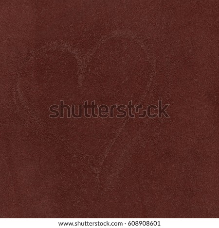 scratched heart pattern on a piece of leather
