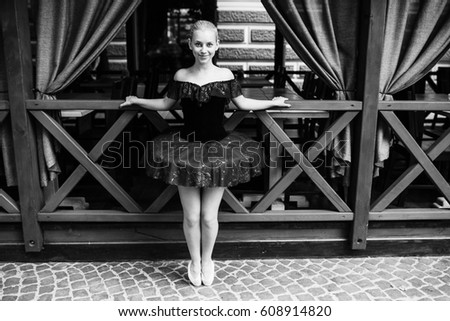 Ballerina posing in the center city on the camra