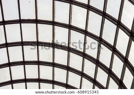 Dome ceiling with hexagonal windows in a covered market; grid structures of steel and glass.