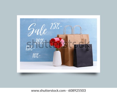 Mockup of blank shopping bags. Sale discounts. Gerbera flowers in vase. Brown and black craft packages. Concept for sales or discounts. Blue wooden rustic board. Photo frame design with shadow.
