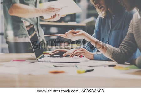 Group of young coworkers working together in modern office.Woman talking with colleague about new startup project.Business people brainstorming concept.Horizontal,color filter Royalty-Free Stock Photo #608933603