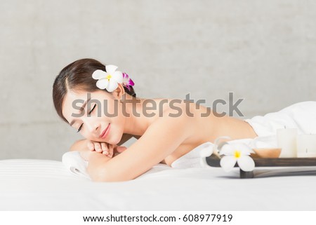 Portrait of Asian people, beauty, spa, healthy lifestyle and relaxation concept - close up of beautiful young Asian woman lying with closed eyes and having hand massage in spa salon Royalty-Free Stock Photo #608977919
