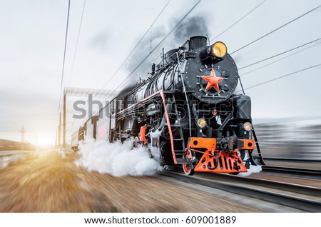 Vintage black steam locomotive train rush railway. Royalty-Free Stock Photo #609001889