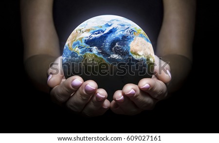 Earth in the hands isolated on black background. Elements of this image furnished by NASA. Space art. Astronomy and science concept. Earth day theme Royalty-Free Stock Photo #609027161