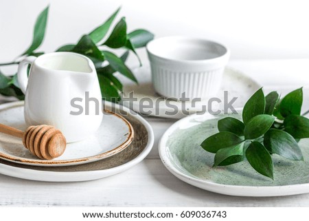 ceramic tableware with flowers on white background